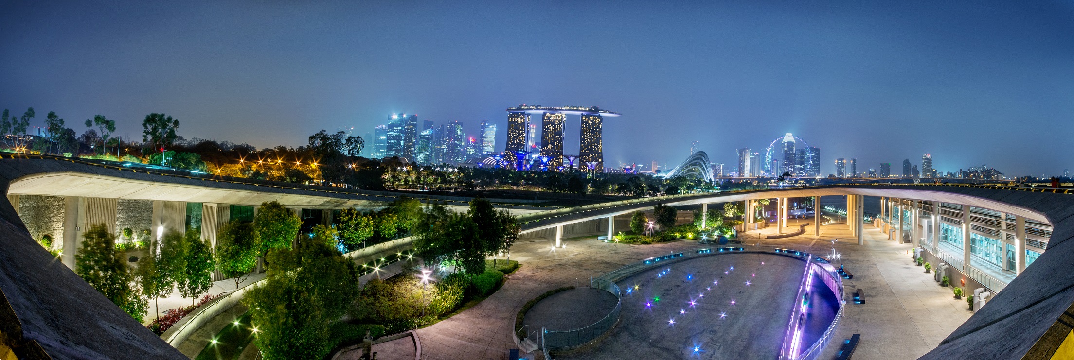 A night shot of Marina Barrage with Marina Bay Sands, Flowers Dome and the Marina Bay buildings.